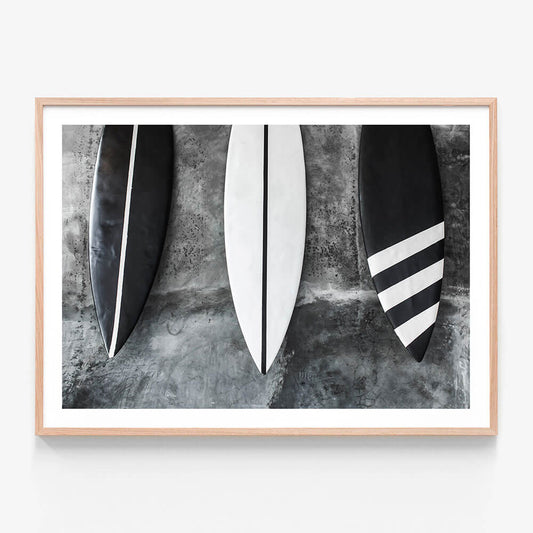A framed photo wall art print featuring Black and white Surfboards