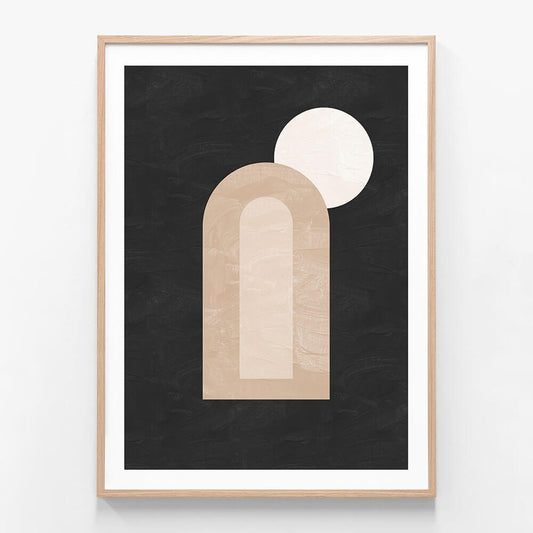 A minimalist framed artwork featuring abstract dark and light shapes, with a prominent arch and a circle, on a black background.