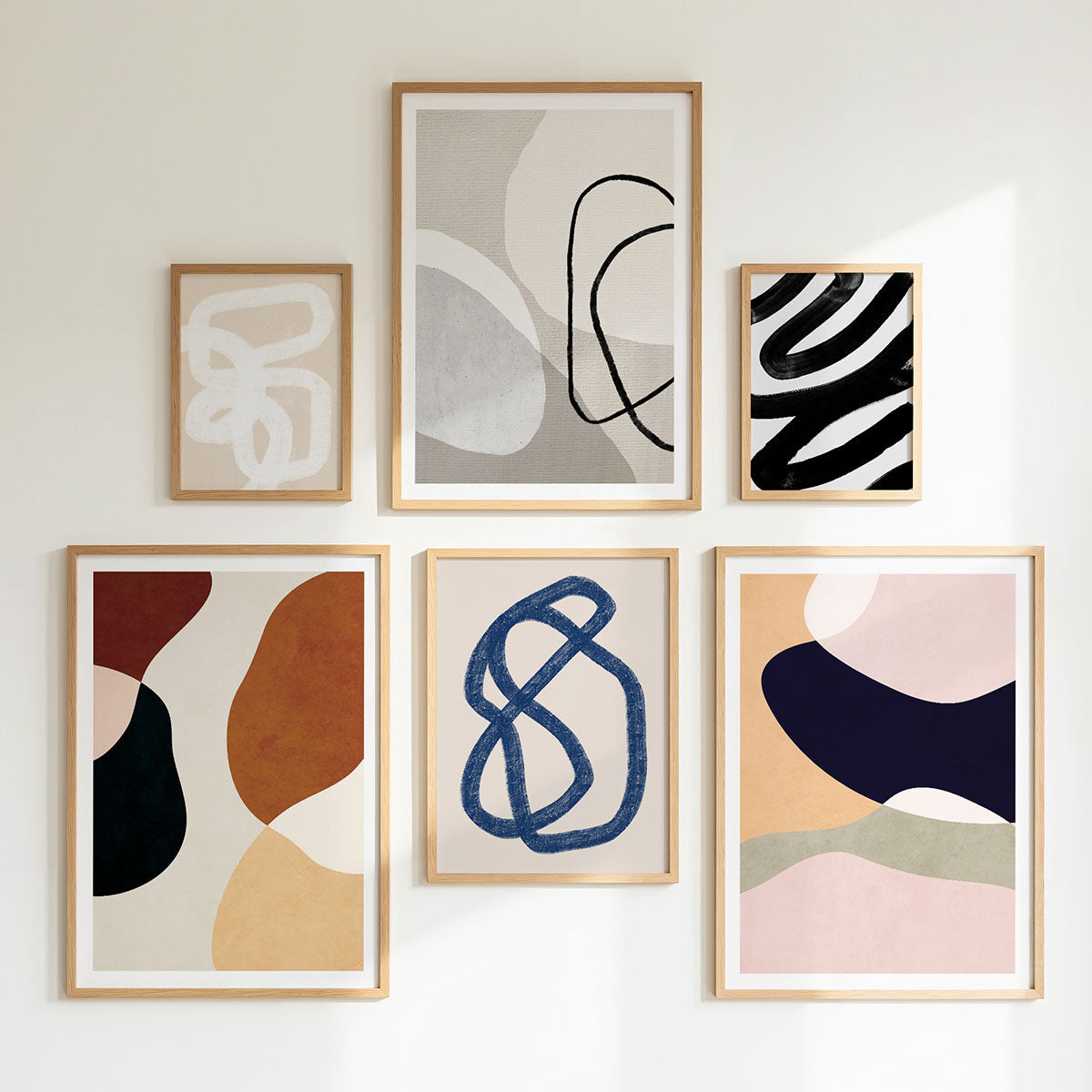 A gallery wall of Minimalist framed art prints.