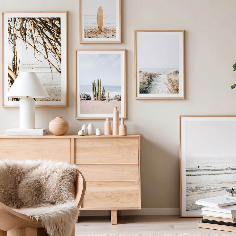 A gallery wall of coastal wall art prints featuring in the ocean and beach.