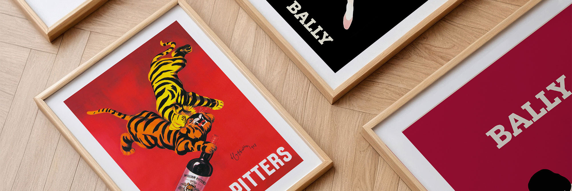 A collection of framed vintage advertisement poster art prints.