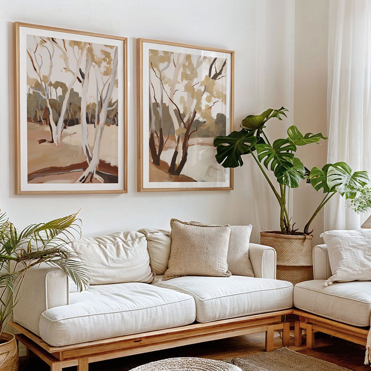 Living room with a white sofa and framed artwork prints featuring abstract landscape art.