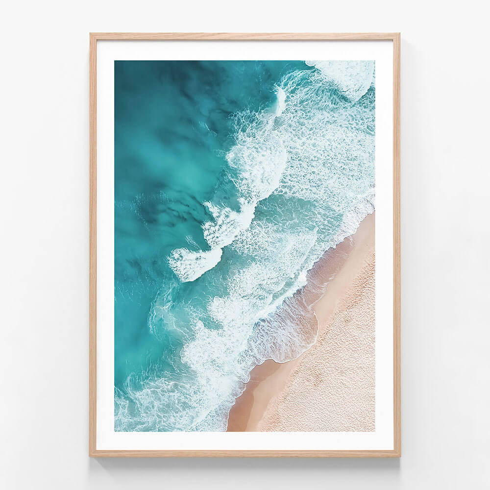 A framed photo wall art print featuring an overhead beach coastal scene