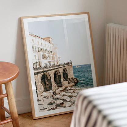 Framed photography print of a Amalfi Coast scene with buildings and ocean on a wall.