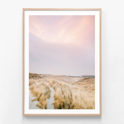 A framed print of a coastal beach scene in Australia with grass