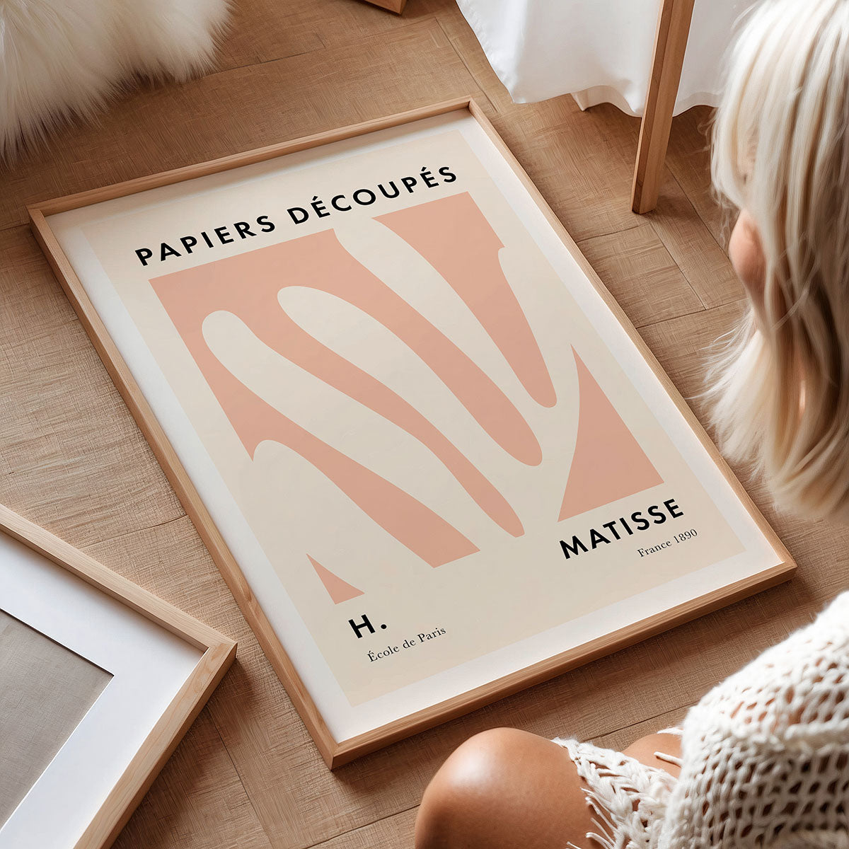 Framed art print titled 'Papiers Découpés' by Matisse on a wooden floor.