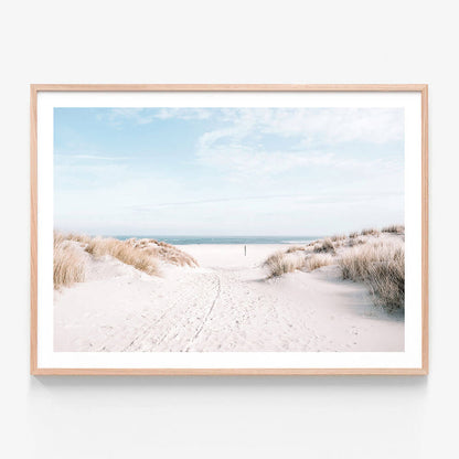 A coastal framed print of a beach photograph with sand and the ocean