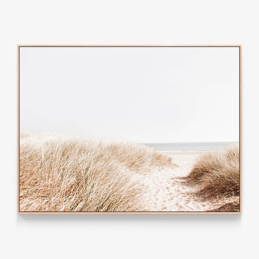 A coastal photo of beach grass  by the ocean canvas wall art print with oak float frame