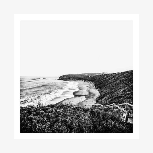 A black and white photography print of a coastal ocean scene with Bells beach and surf, looking towards a headland.