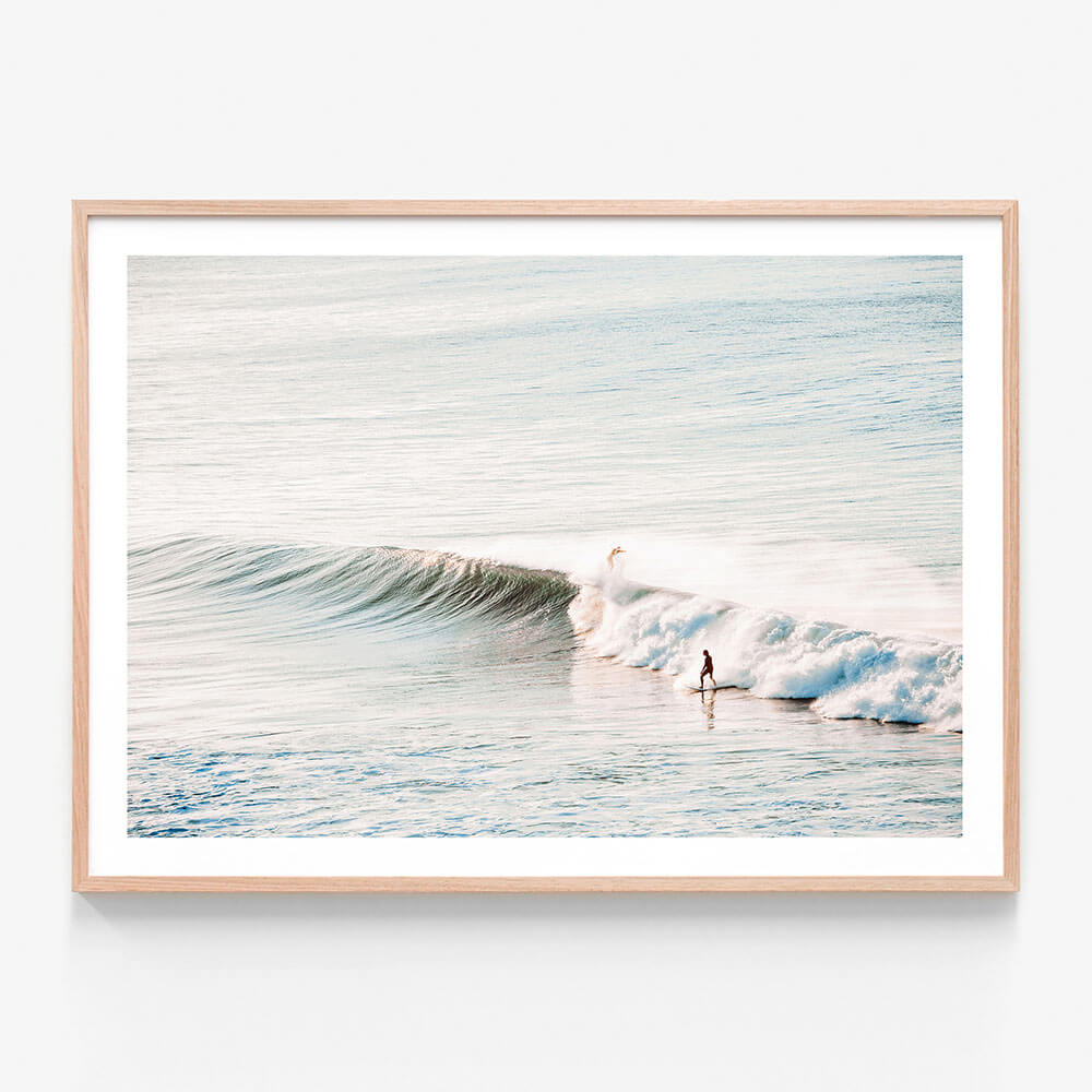 A framed wall art print featuring a surfer riding a wave at Bells Beach