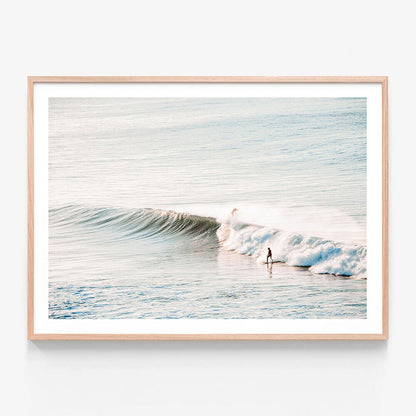 A framed wall art print featuring a surfer riding a wave at Bells Beach