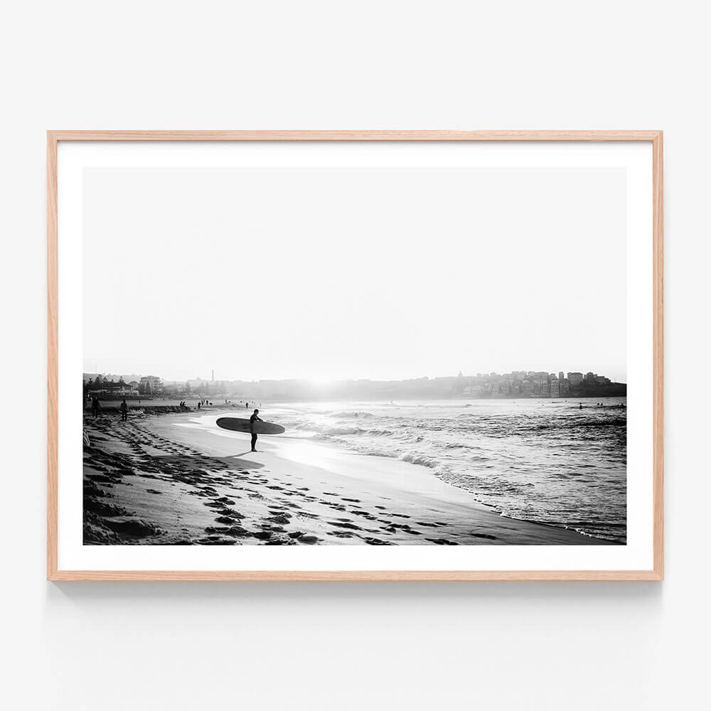 A black and white framed art print of a surfer on Bondi beach.