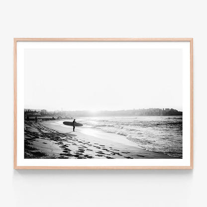 A black and white framed art print of a surfer on Bondi beach.