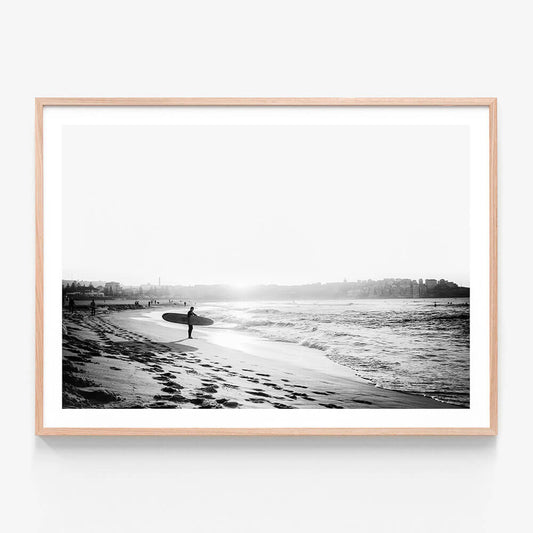 A black and white framed art print of a surfer on Bondi beach.