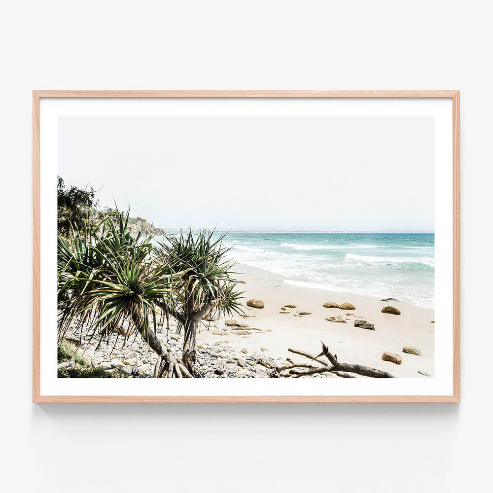 A framed print featuring the beach at Byron Bay Australia.
