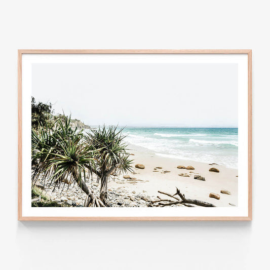A framed print featuring the beach at Byron Bay Australia.
