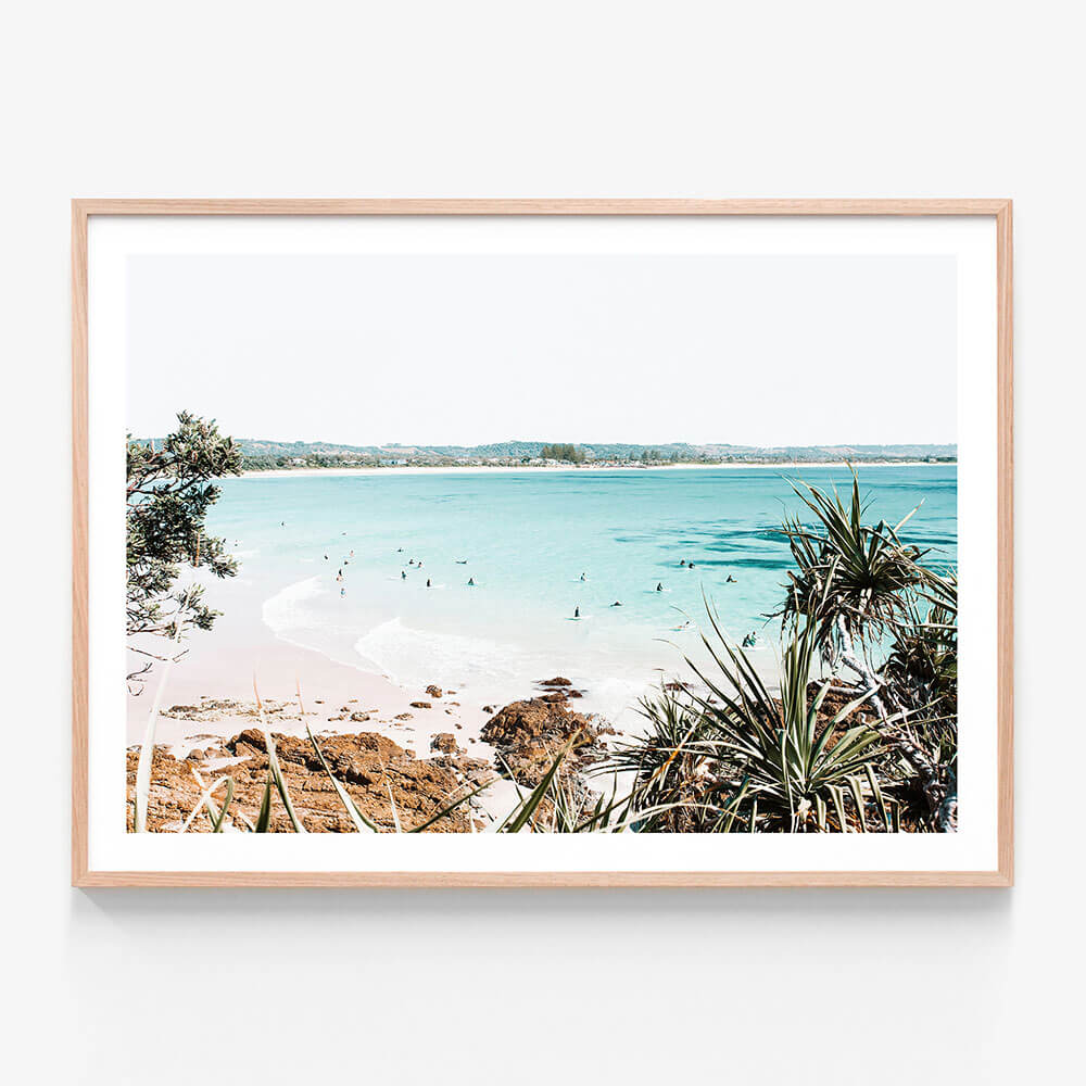 A framed art print featuring a photo of the beach at Byron Bay