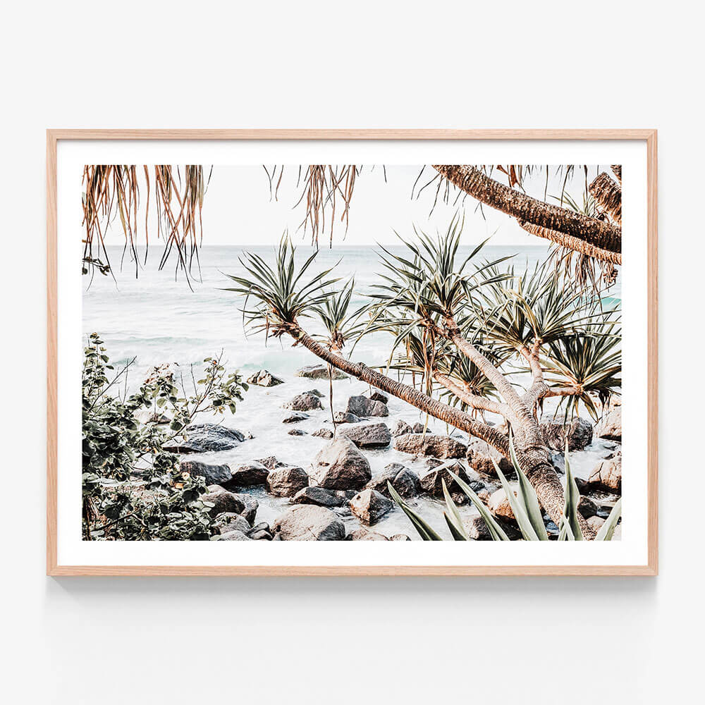 A framed photo wall art print featuring pandanus palms next to the ocean by the beach in Noosa