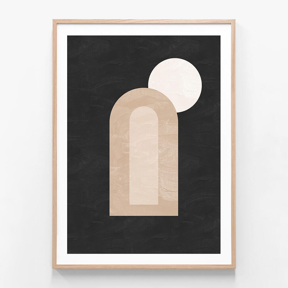 A minimalist framed artwork featuring abstract dark and light shapes, with a prominent arch and a circle, on a black background.