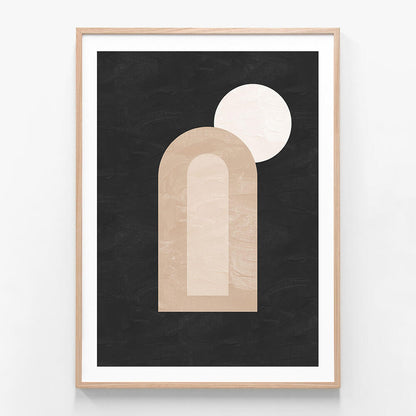 A minimalist framed artwork featuring abstract dark and light shapes, with a prominent arch and a circle, on a black background.