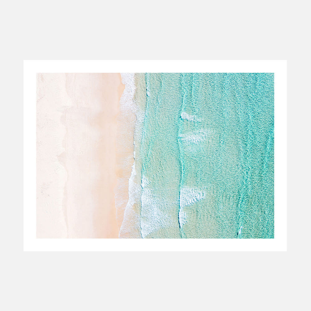 A coastal wall art print featuring the beach from overhead