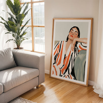 Framed artwork of a woman in a living room with a couch and plant.