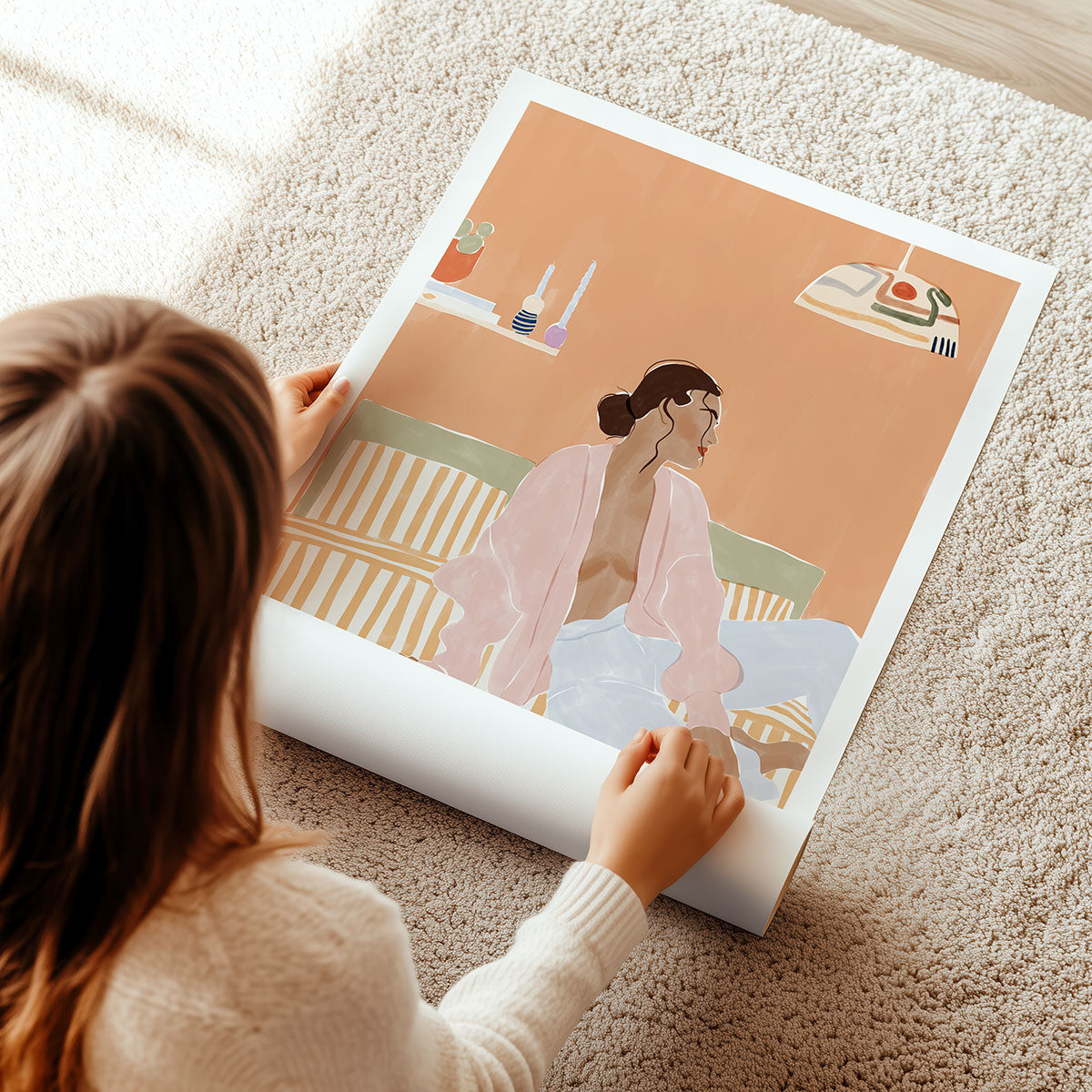 Person unrolling a modern figurative wall art illustration of a woman on a bed.