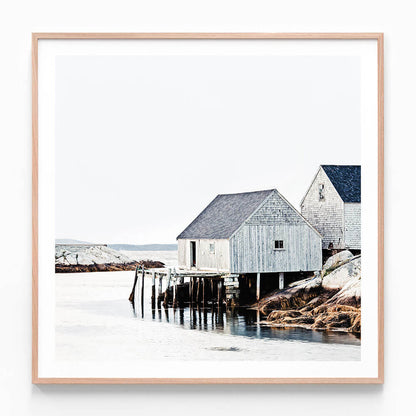 A Scandinavian print of a fishing shack by the water, predominantly in white and blue colors with a minimalist coastal style.