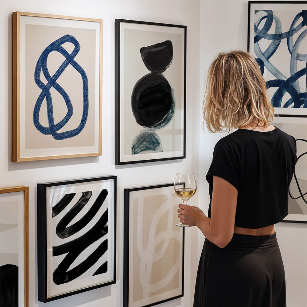 A gallery wall of framed abstract art prints.