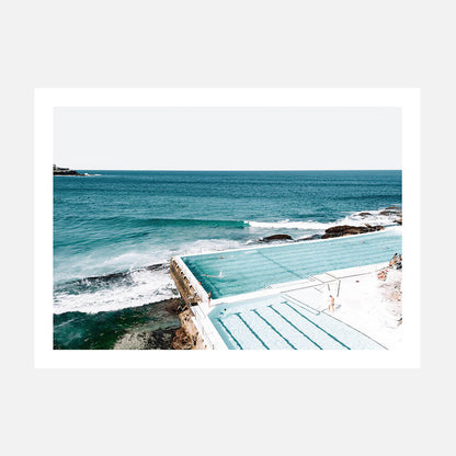 A print of a coastal ocean scene with the Bondi icebergs pool in the foreground and the sea in the background, featuring blue sky and waves.