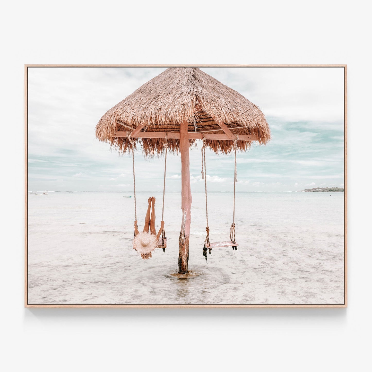 Girl on a swing on the beach canvas wall art print with oak float frame