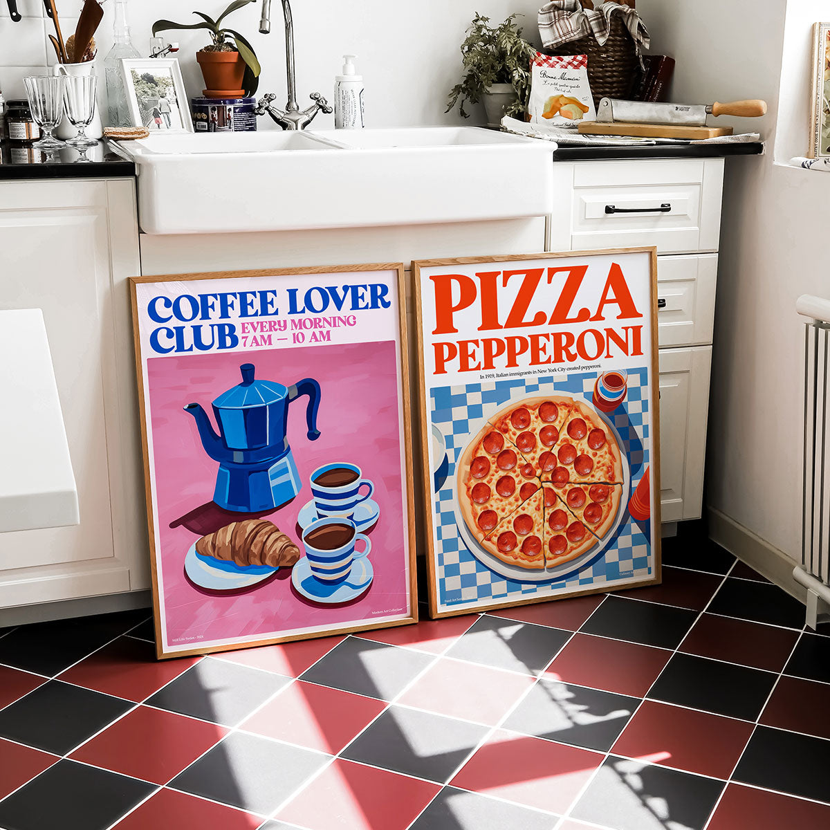Two framed prints, one of a coffee lover club and the other of a pizza pepperoni, in a kitchen.