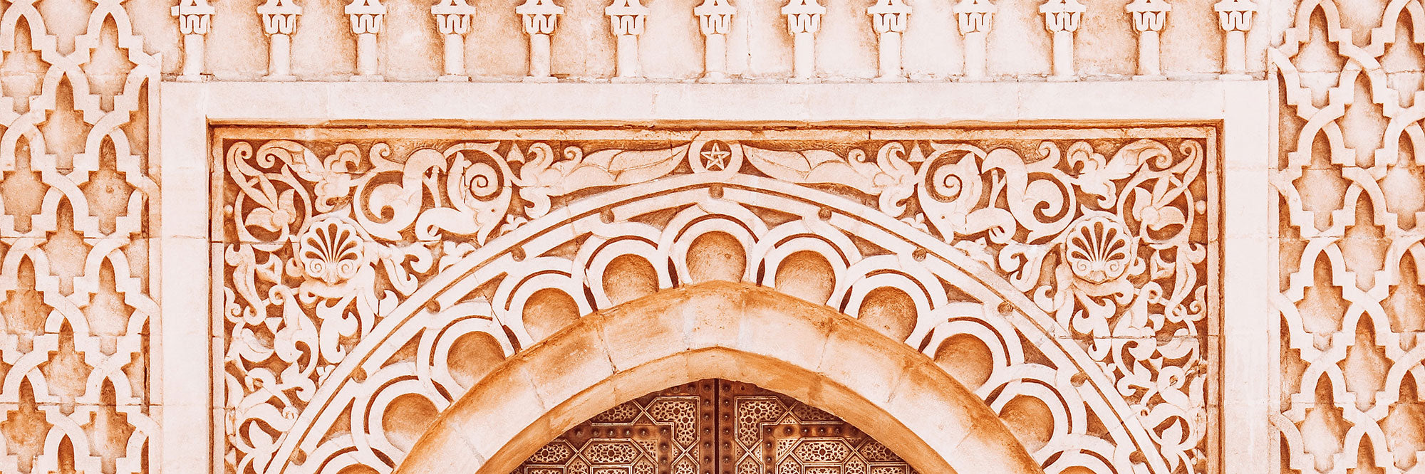 Decorative Moroccan archway with intricate patterns in a warm colour palette