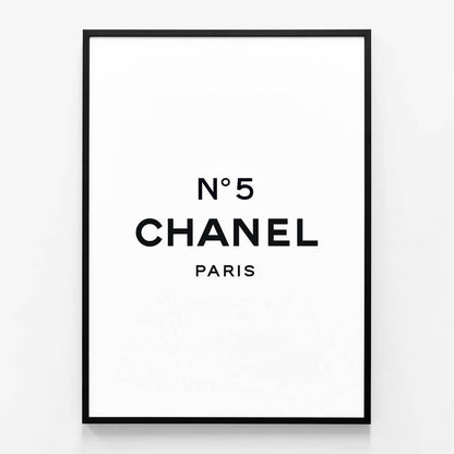 A framed art poster of Chanel No 5 with a black frame