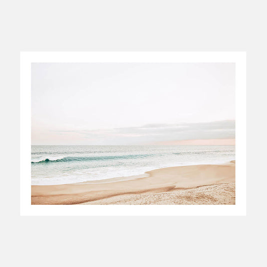 A pastel-colored photography art print of a coastal scene with a beach and ocean waves in the background.