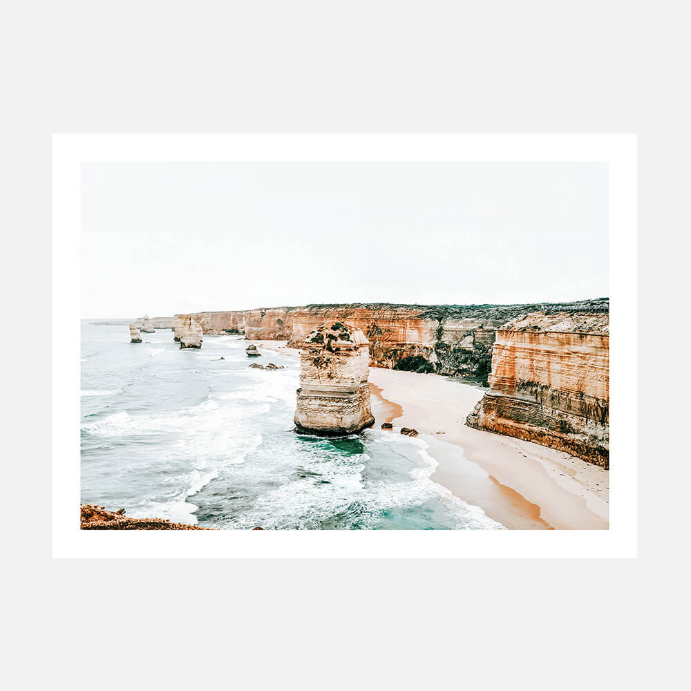 A printed artwork depicting a coastal scene with cliffs and the ocean along the great ocean road near the 12 apostles. 