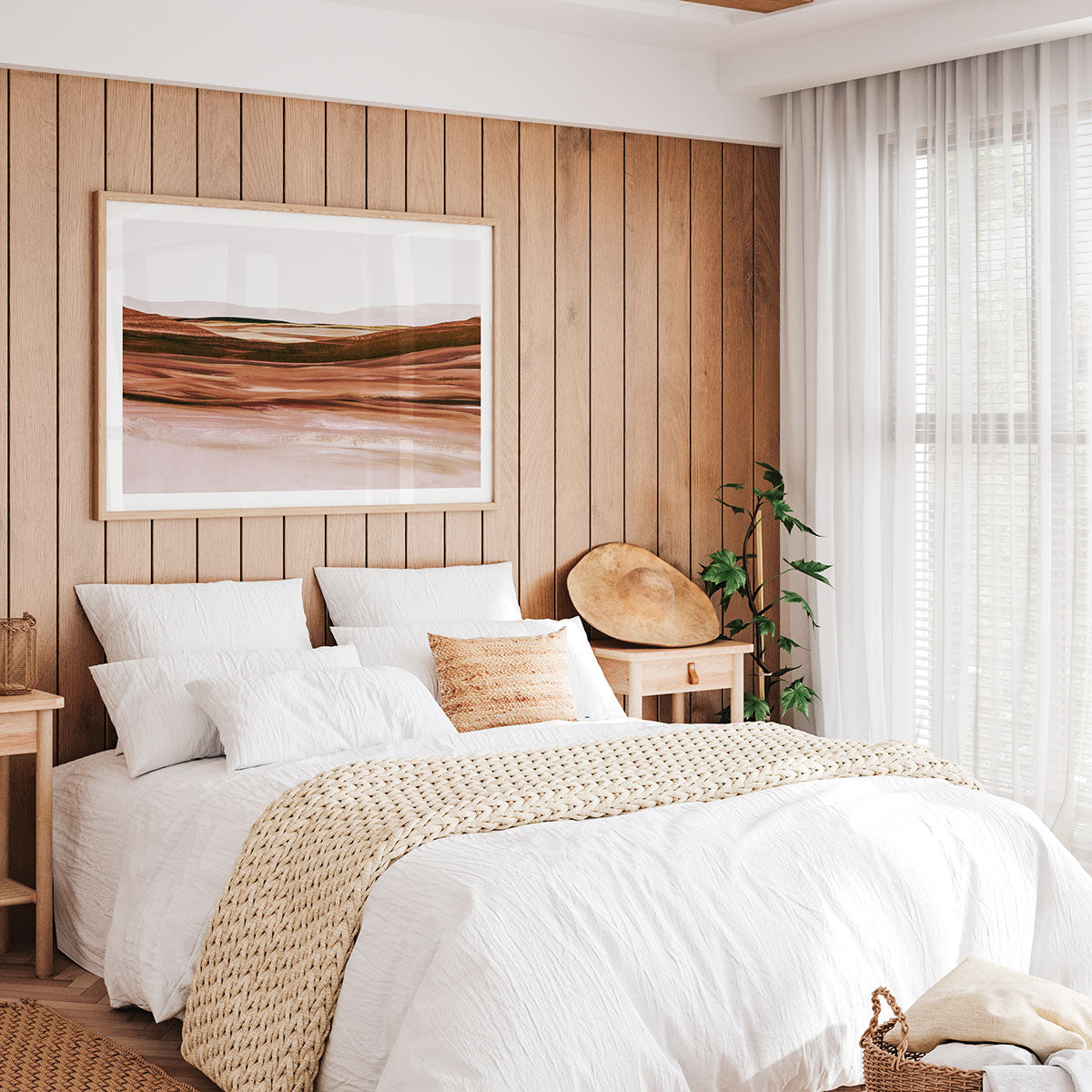 Neatly made bed with white bedding and beige blanket in a bedroom with a framed print of an abstract landscape painting having on the wall.