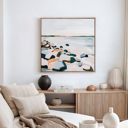 Abstract landscape art canvas print on a wall above a wooden sideboard with decorative items in a living room.