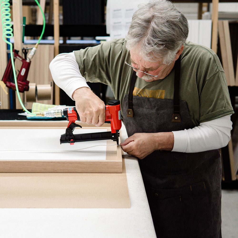Steve framing a wall art print in the factory