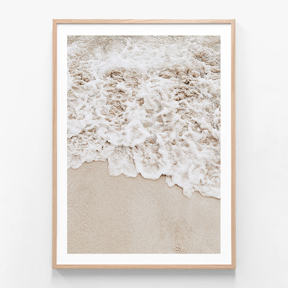 A framed photo wall art print featuring a close up of the tide coming in on the sand