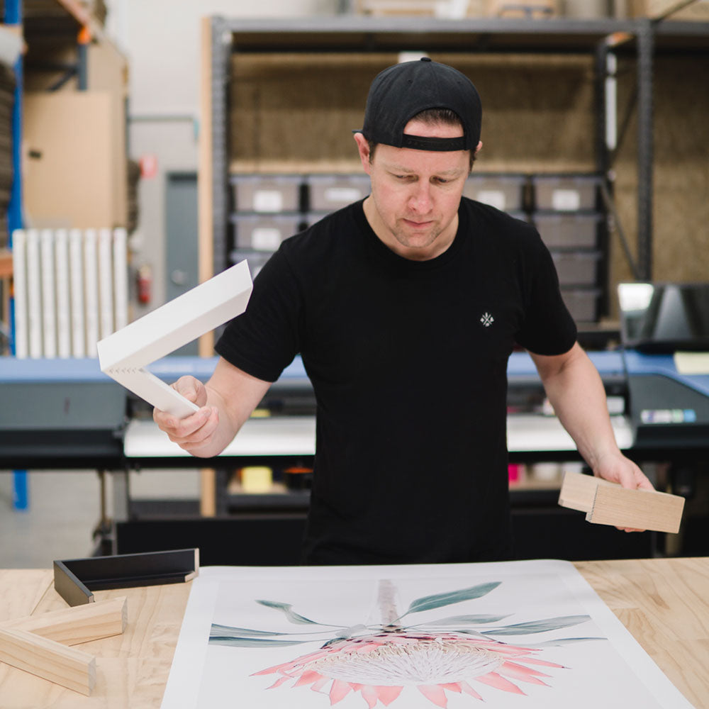 Tim working with a printed artwork in our Geelong framed print factory