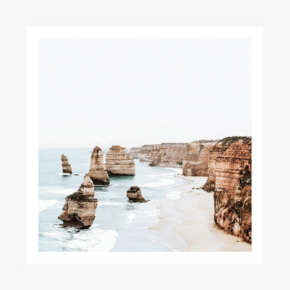 A photo showcasing the Twelve Apostles rock formations along the great ocean road coast of Australia with the ocean in the background.