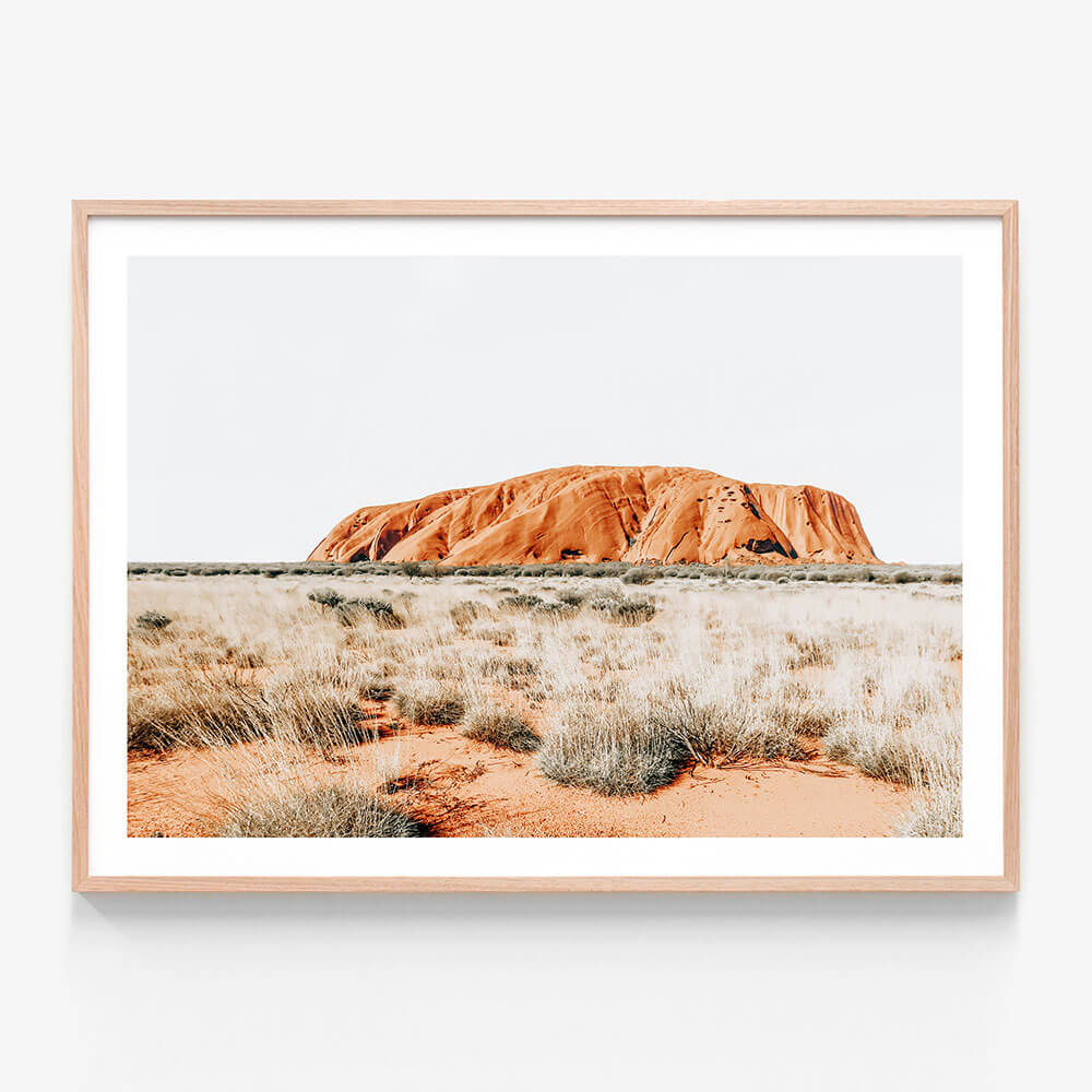 A photography framed print of Uluru - Ayres rock in the Australian outback.