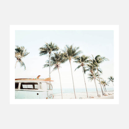 A photo print of a vintage van parked near a beach with palm trees in the background.